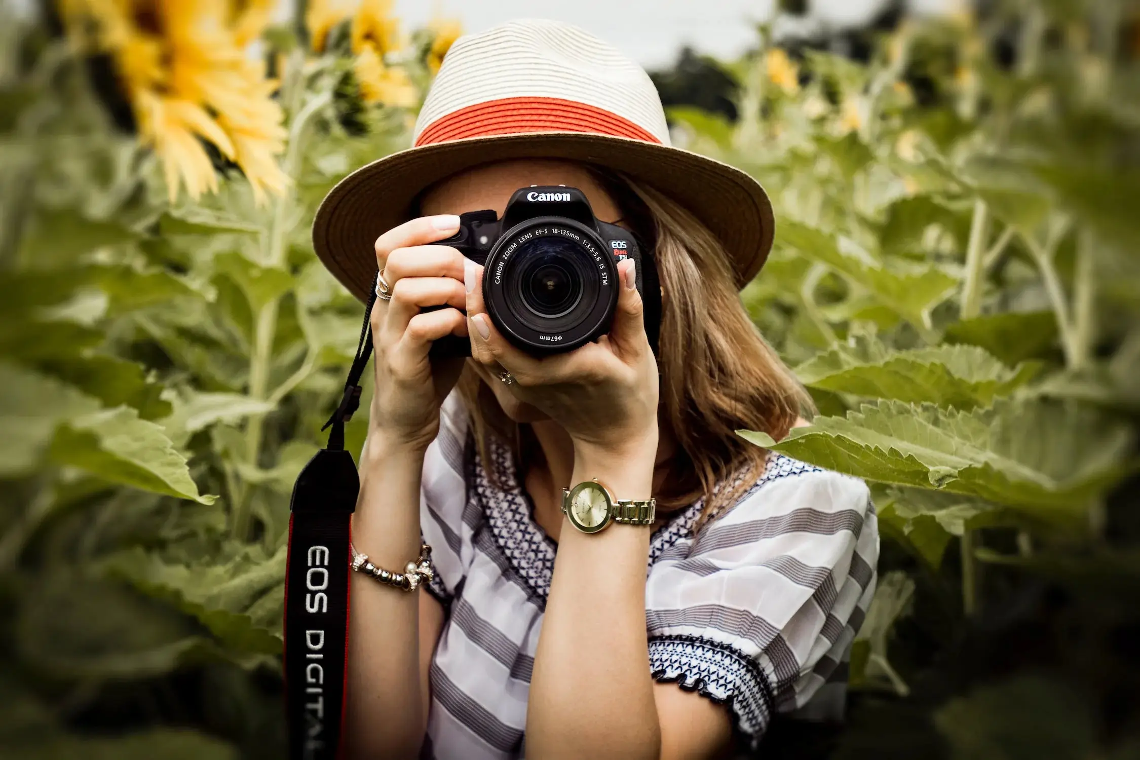 Photo of a woman shooting with a DSLR camera