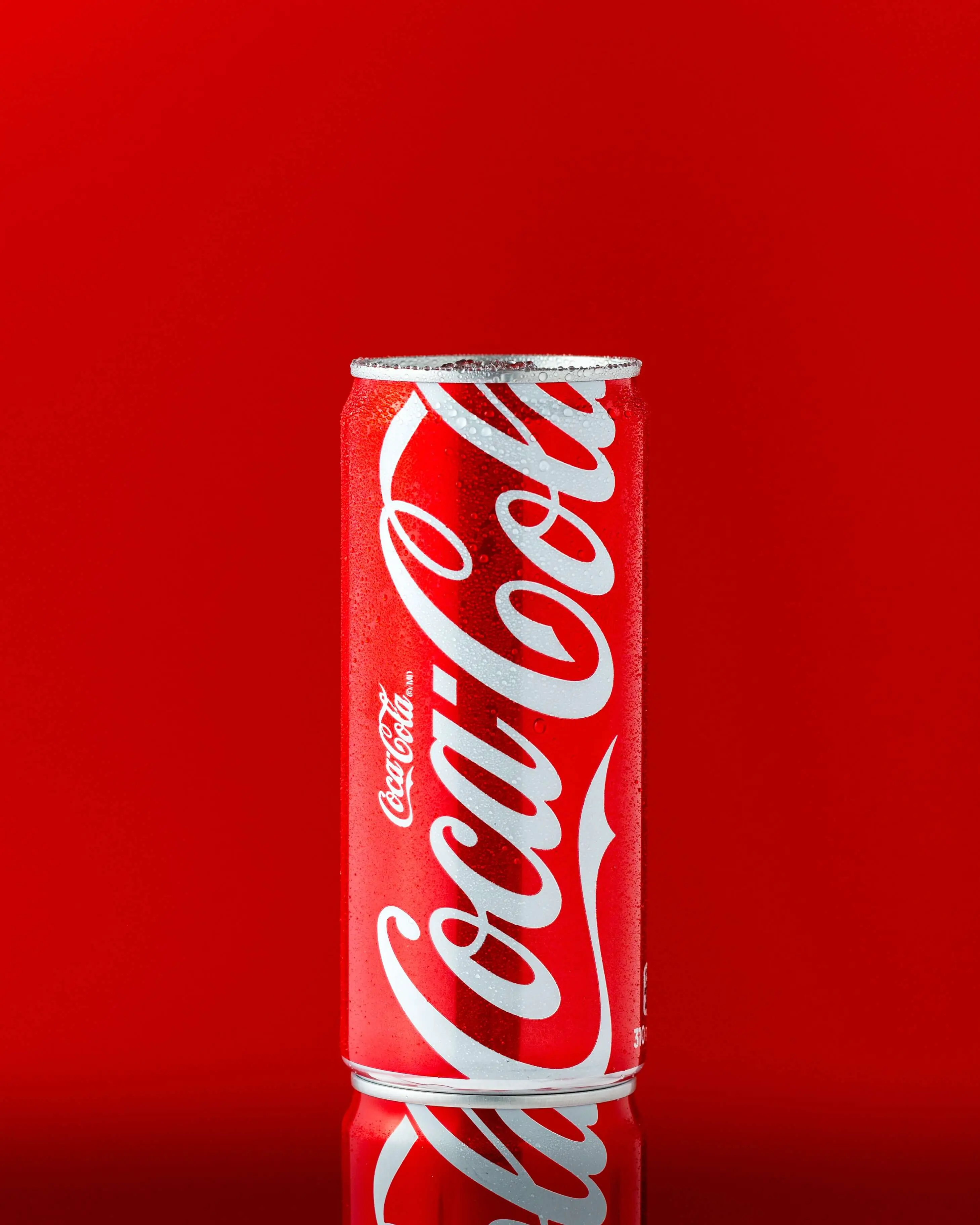Photo of a Coca Cola can on a red background